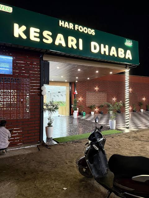 Kesari Dhaba entrance at night with the green 24x7 signboard
